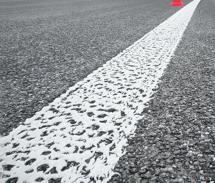 Irregular aggregate in road markings for improved visibility and traction